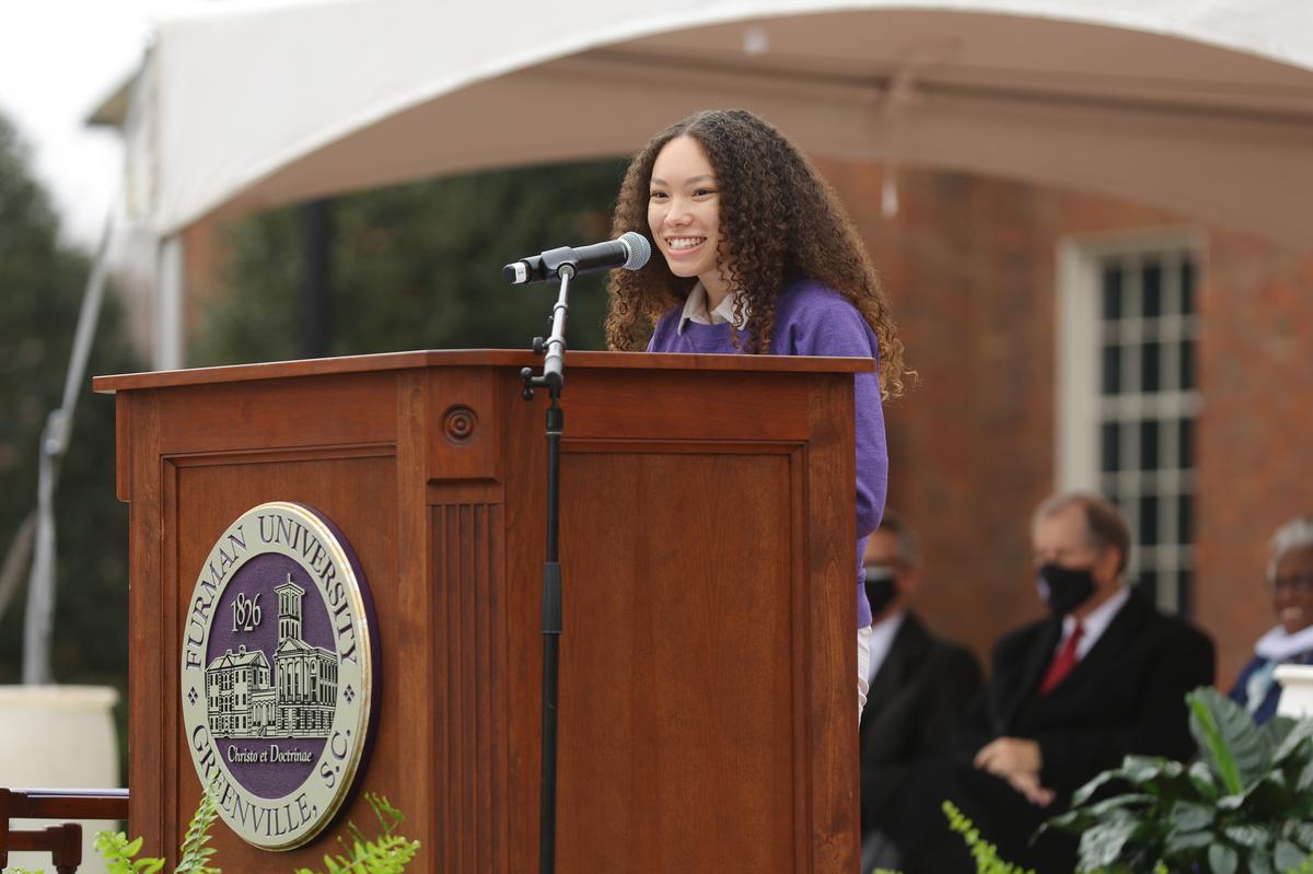 Asha Marie '22, Student Body President, speaking in front of the Joseph Vaughn statue.