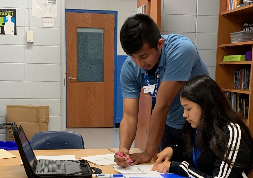 José Morales Martinez '18 working with a student in a Greenville high school.