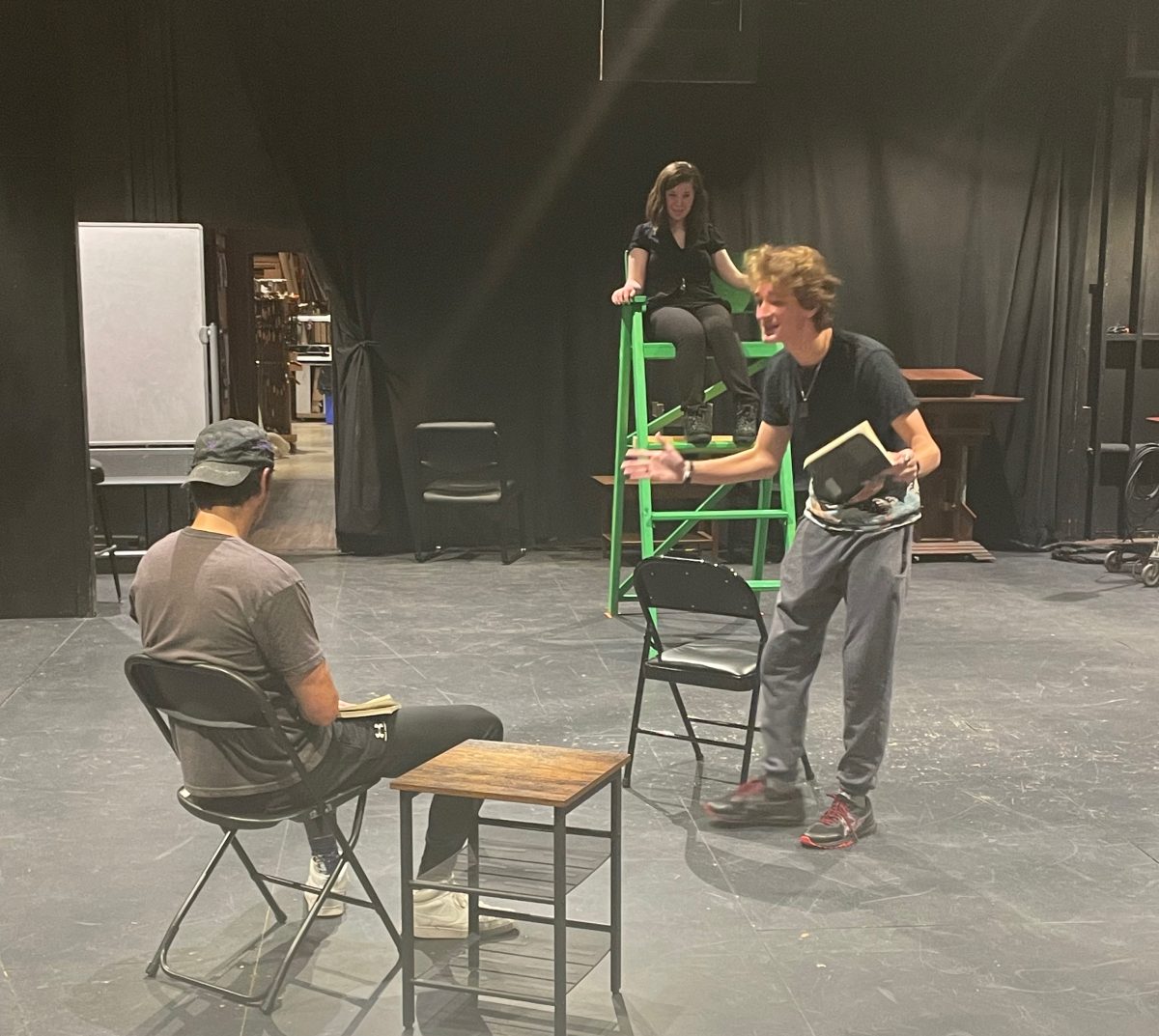 A photo from rehearsals. From left to right: Isaac Gibbs 23 as Bill, Paige Hemmer 25 as The Referee, and Cian Colgan 26 as Frank.