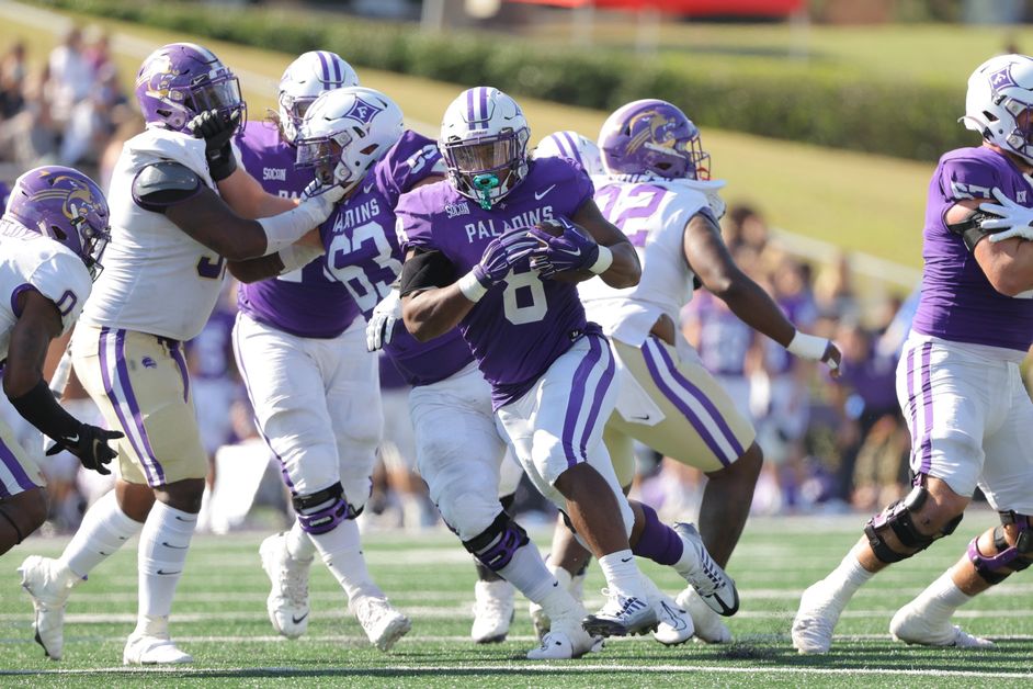 Furman+RB+Dominic+Roberto+squeezes+past+the+Catamount+defensive+line+for+a+solid+rush.