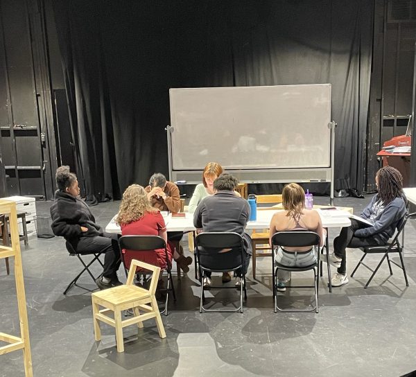 A photo from the table work process during rehearsals. From left to right: Ciara Cox '25, Dayanari Umaña ‘18, Zoee Lawrence '25, director Ahsha M. Daniels, Andra Enache '24, Ja'mese Corbitt '26, and Lucy Gamblin '26