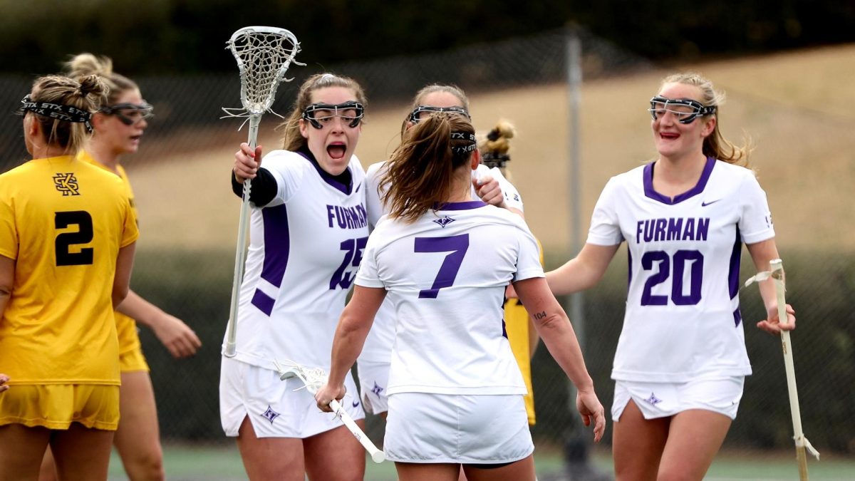 The Paladins celebrate a goal in a 15-11 win over Kennesaw State on Feb. 18. Junior attack Anna Roser broke a school record with nine goals in the contest. 