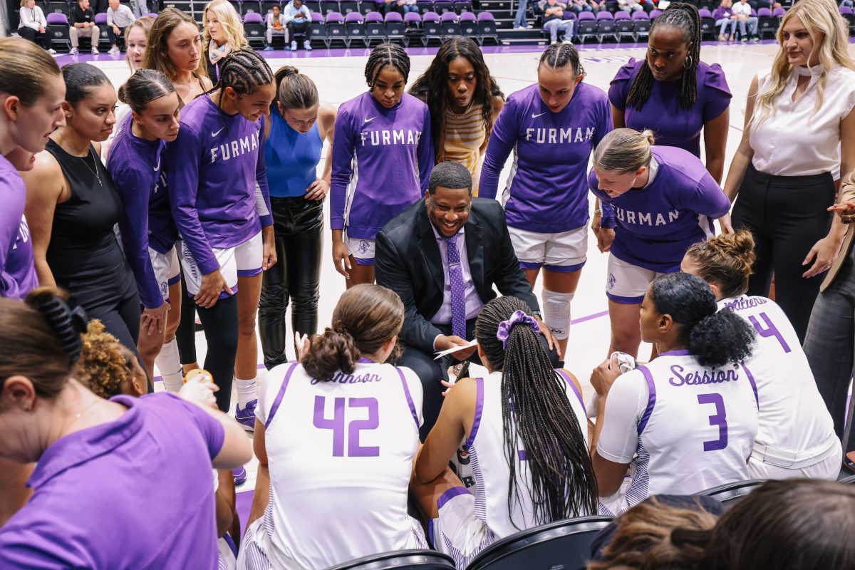 Curtis+huddles+with+his+team+in+his+first+game+as+head+coach+on+Nov.+7+when+the+Paladins+defeated+UNC+Asheville+71-61.