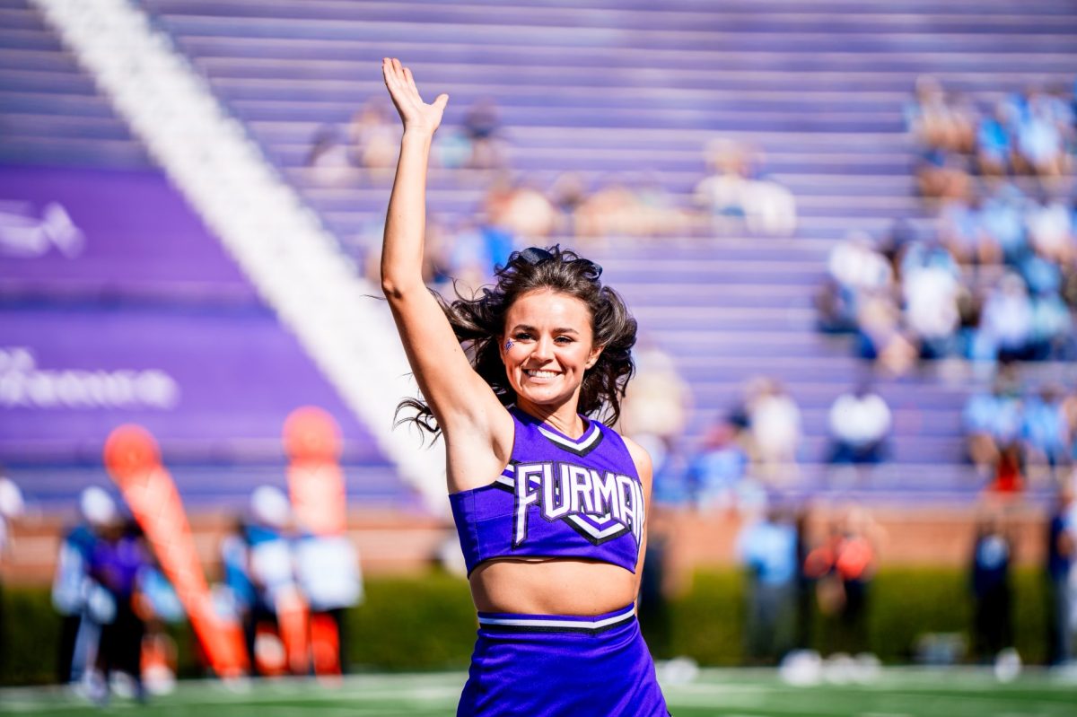 Senior Makenna Connolly shows spirit while cheering at a Paladins football game.